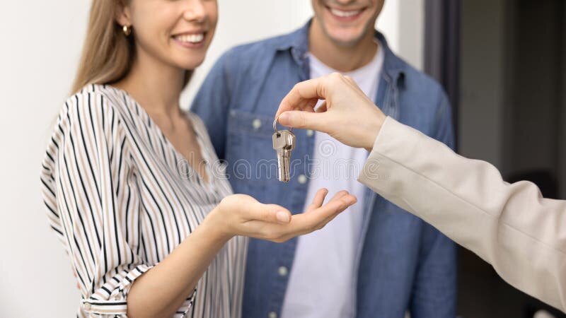 Young couple receiving keys to their first home in Australia
